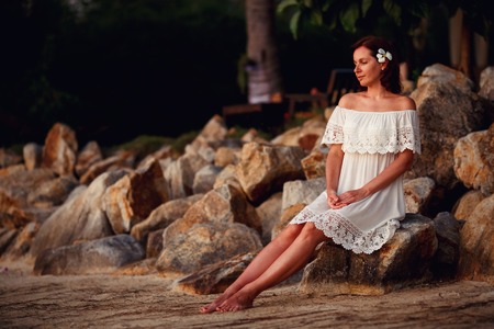 Young woman relaxing outdoors on beautiful summer eveningの写真素材