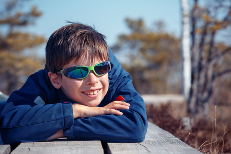 Cute little boy having rest outdoors on beautiful spring dayの写真素材