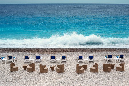 Chairs and tables on Nice beachの写真素材