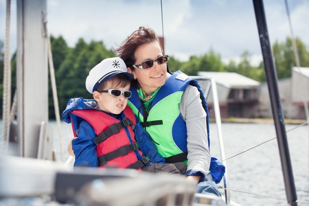 Family of two enjoying boat ride at lakeの写真素材