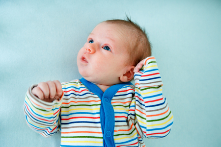 Emotional baby lying in cradleの写真素材