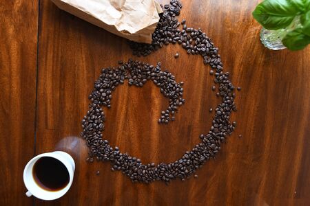 Home made coffee with coffee beans in a swirl patternの写真素材