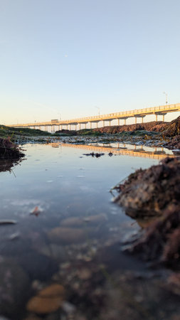 Ocean Beach Pier in San Diego California during king tides at low tide where the tidal pools are visible.の写真素材
