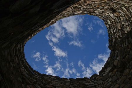 Circular stone wall overlooking it blue sky with cloudsの写真素材
