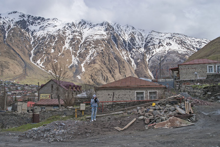 Stepantsminda, Georgia - may 4, 2015: The guy is photographing neighborhoodのeditorial素材