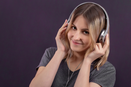 girl in headphones smiling and listening to music, generation z, young people, DJの写真素材