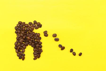 concept tooth of coffee grains. collapses under the influence of coffee copyspace harmful effects of coffee on the teethの写真素材