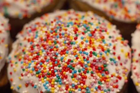 Easter cake with multicolored icing and sprinkles at the spring holidayの写真素材