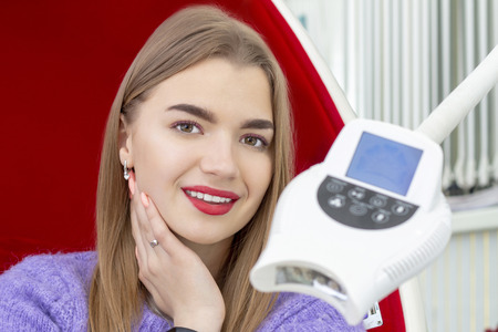 teeth whitening girl smiling with whitened white teeth after the procedureの写真素材