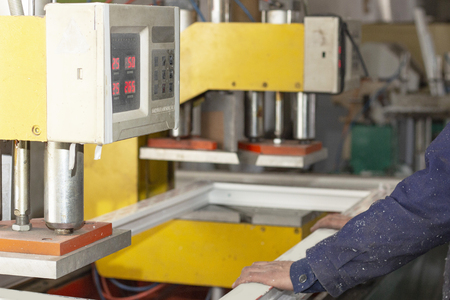 machine assembly of plastic window frames at the factory making plastic windows workflowの写真素材