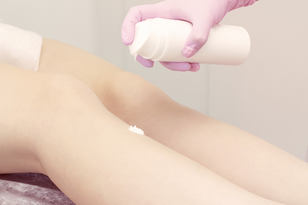 cosmetic procedure applying cream on the legs depilation epilation skin softeningの写真素材
