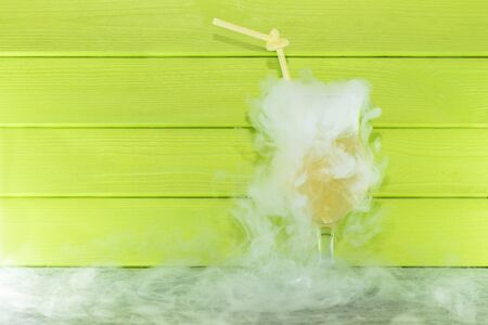 cocktail with liquid nitrogen. Summer cooling cocktail in a glass glass with a straw. from liquid nitrogenの写真素材
