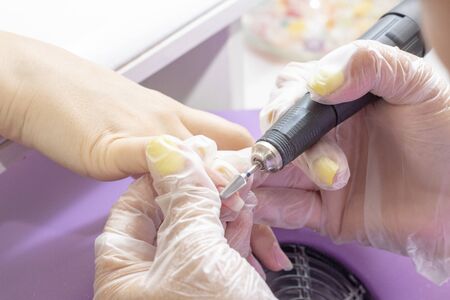 hardware manicure. Gellak removal. shellac coating nail plate treatment with manicure machineの写真素材