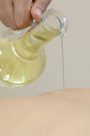 massage oil. Spa massage. Body care, skin care, wellness, wellbeing, beauty treatment concept. vertical photoの写真素材