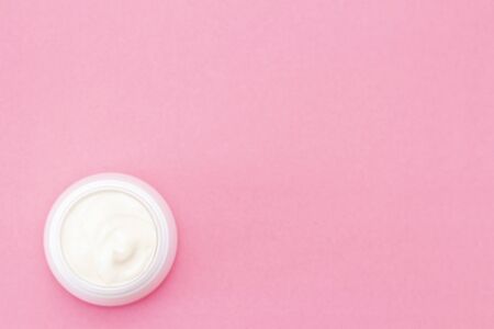 jar of cream on a pink texture background. skin care for the face, body, arms, legs. Health concept. Winter and summer care. copyspace. Place for textの写真素材