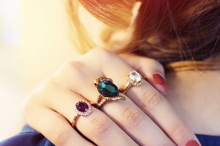 Close up of an elegant ring with stones on woman's hands. concept of wealth, jewelry. Many rings on the fingers.の写真素材
