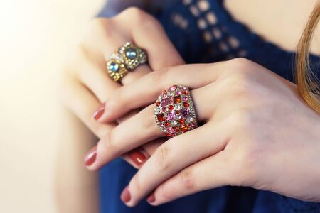 Close up of an elegant ring with stones on woman's hands. concept of wealth, jewelry. Many rings on the fingers.の写真素材