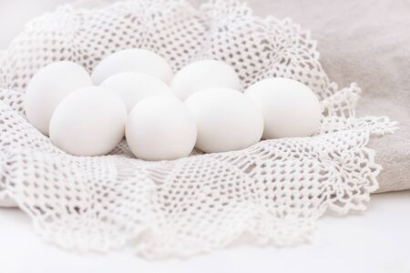 pile of organic white eggs of chicken healthy eating freshness on a brown bag and a white beautiful...