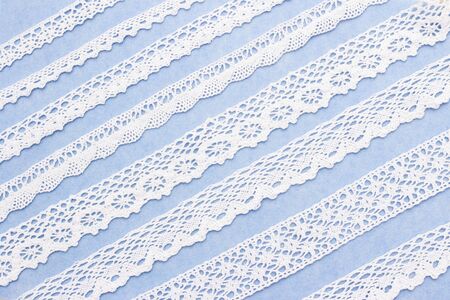 abstract background. white lace on a blue background. Lace of different widths. studioの写真素材