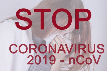 Coronavirus inscription in red, the word stop, 2019-ncov. Against the background of a sick girl who sneezes.の写真素材