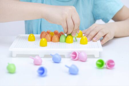 development of fine motor skills in children. Picking up the mosaic. hands of a child close-up....
