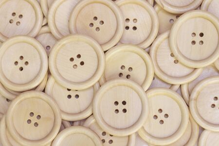 Buttons background from a natural tree. wooden buttons without painting closeup. vintage
