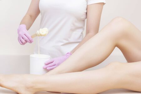 Sugaring. Depilation with sugar. Woman having legs hair removal procedures in a salon. Depilation conceptの写真素材
