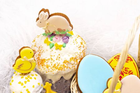Easter holiday. Easter gingerbread chicken and rabbit on the Easter cake.  on a light background.