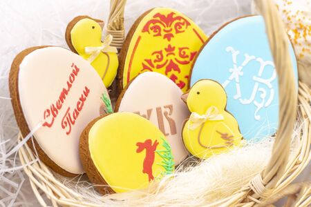 Easter holiday. Easter gingerbread chicken, eggs on the Easter cake. on a light background....