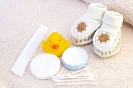 baby hygiene and bath items, shampoo bottle, baby soap, towel, yellow duck rubber toy, cotton pads...