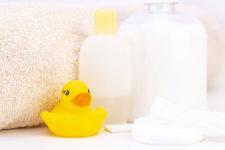 baby hygiene and bath items, shampoo bottle, baby soap, towel, yellow duck rubber toy, cotton pads...