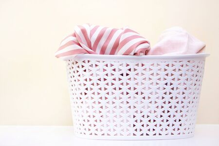 white basket with dirty linen. laundry and home cleaning conceptの写真素材