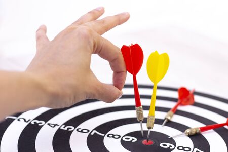 Right to Target Concept Using Darts in Bulseye on Darts Business Success Concept. destruction of competition. one arrow in bulseye, three red arrows fellの写真素材