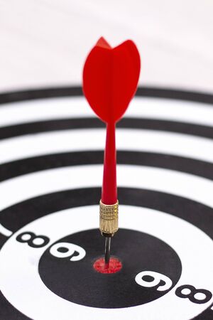 Dartboard with hit bullseye on white background, closeup. Bullseye is a business target. Target...