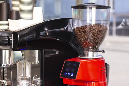 Close up shot of professional bartender preparing espresso coffee in exclusive cafe bar or cafeteria. He using coffee mill or grinder.の写真素材