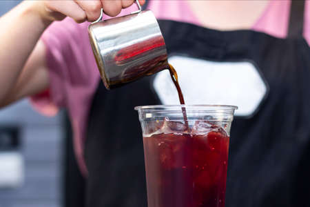 Ice coffee preparation preparation service concept. Barista. makes espresso in a coffee shop;...