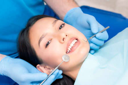 dentist examines the patients teeth at the dentist.の写真素材