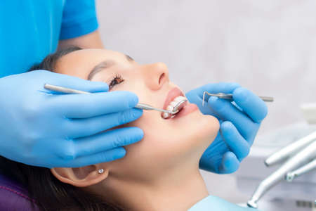 dentist examines the patients teeth at the dentist.