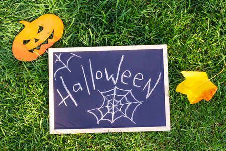 Halloween holiday. Pumpkins, sign with the inscription: Halloween. Backgroundの写真素材