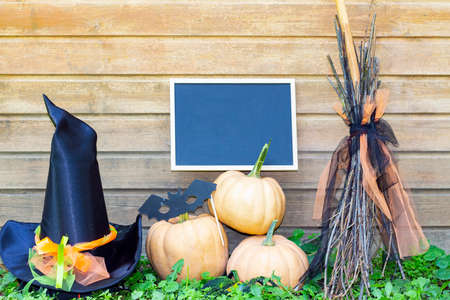 Halloween holiday. Pumpkins, witch hat and mock up sign, witchs broom
