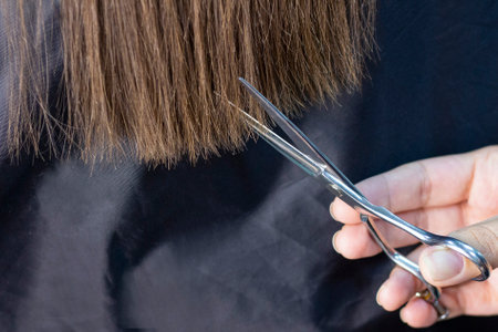 hair care. young woman has scissors in her hands. trimming hair ends