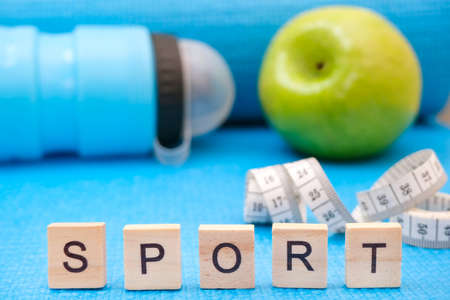 fitness and sports concept. yoga mat, sport letteringの写真素材