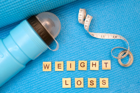 fitness and sports concept. yoga mat, weight loss letteringの写真素材