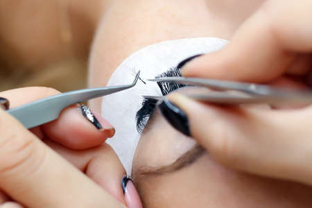 Eyelash extension procedure. Female eye with long eyelashes. Eyelashes, close-up, macro