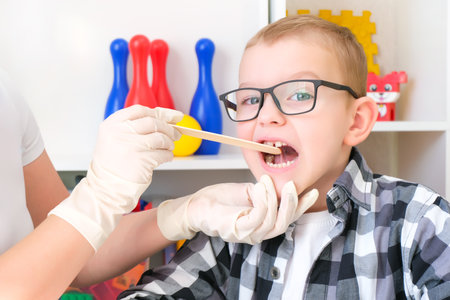 dyslexia treatment. Speech therapy massage of the tongue. Sound production. Developing activities with a boyの写真素材