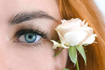 eyelash extension. macro beautiful eye with long eyelashes with a rose