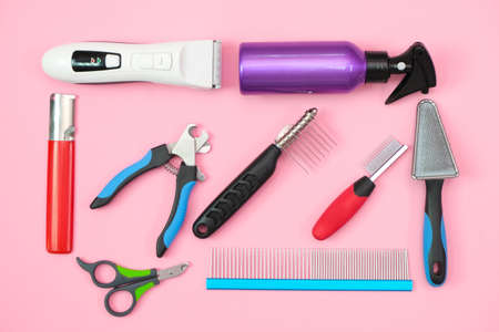 pet care and grooming tools on a pink background. pet care and hygiene conceptの写真素材
