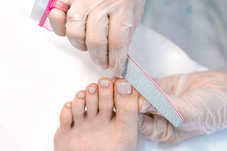 medical pedicure with a nail file. Foot peeling procedure in the spa using a special apparatus. Clinic of Podiatry Podiatry.の写真素材