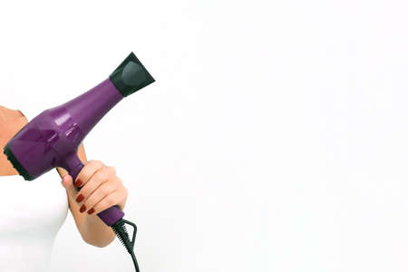Salon. A hairdresser is holding a hairdryer for styling hair. copy space. mock up. Professional hairdresser toolsの写真素材
