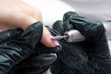Beautician Salon, Manicure. Professional hardware manicure using electric machine in beauty salon....